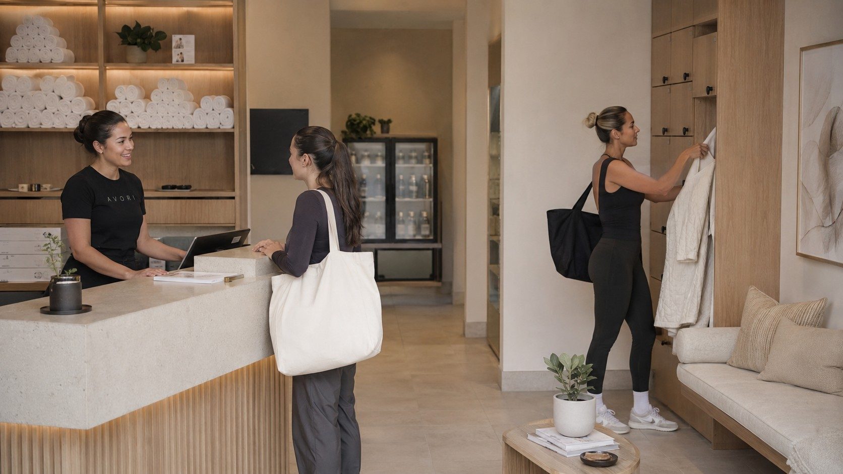 An AVORI host welcoming a guest at a stone reception desk